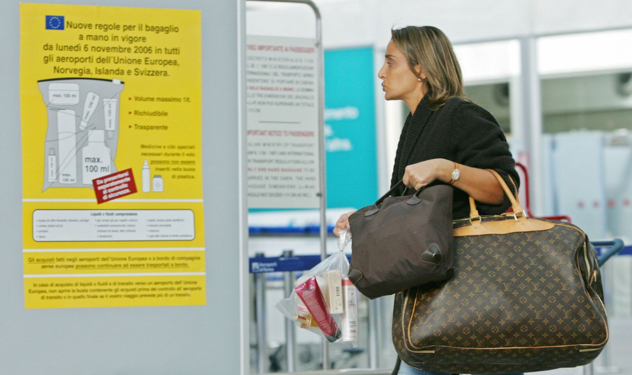 A passenger carrying her items of liquid 72418246