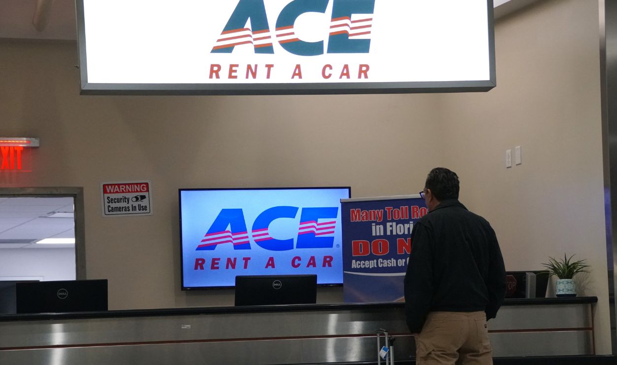 Miami, Florida, U.S.A - September 20, 2024 - A customer patiently waiting in line to get the reservation at Ace Rent A Car