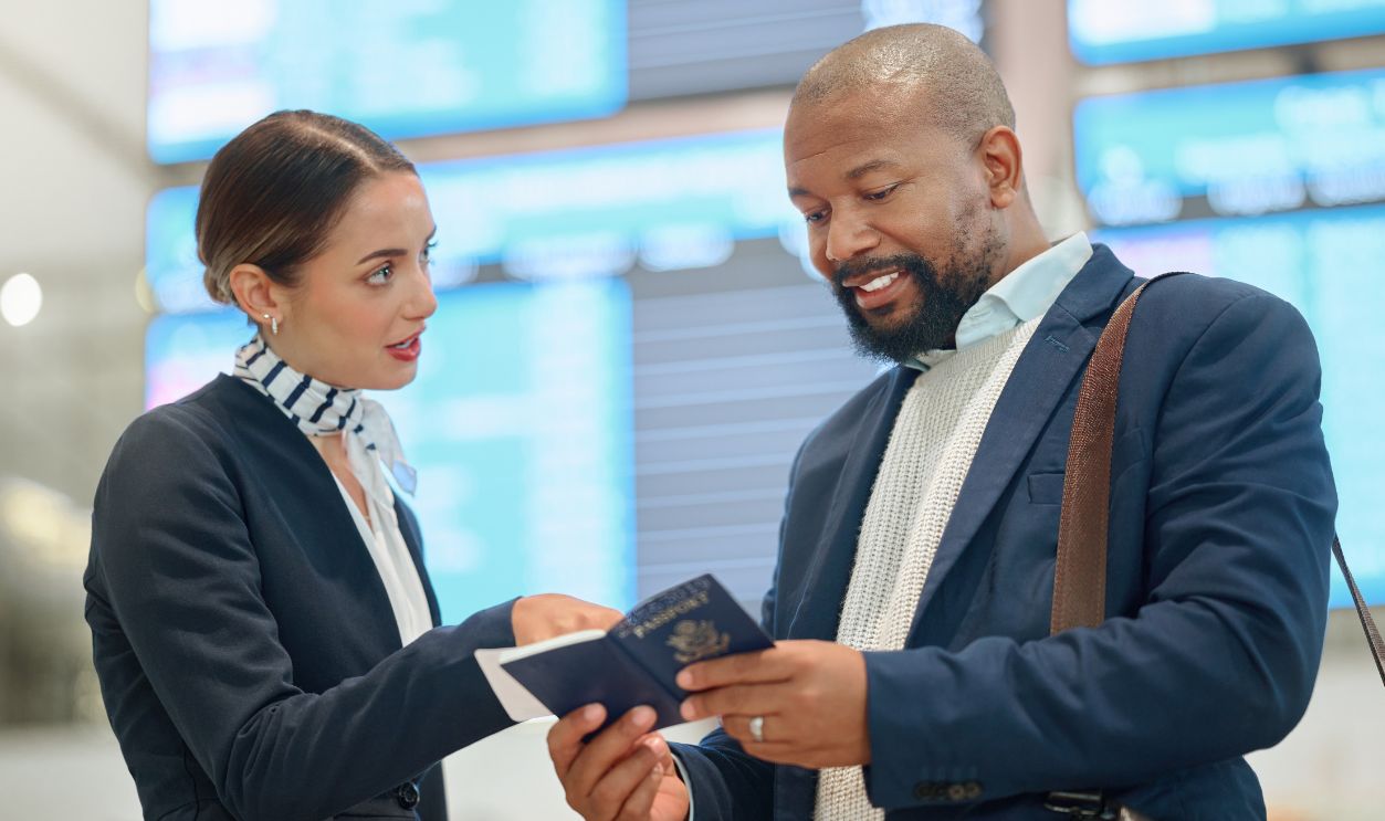 African businessman, passport and airport woman with compliance check, reading and travel policy. Corporate black man, airline worker and documents for international transportation with inspection