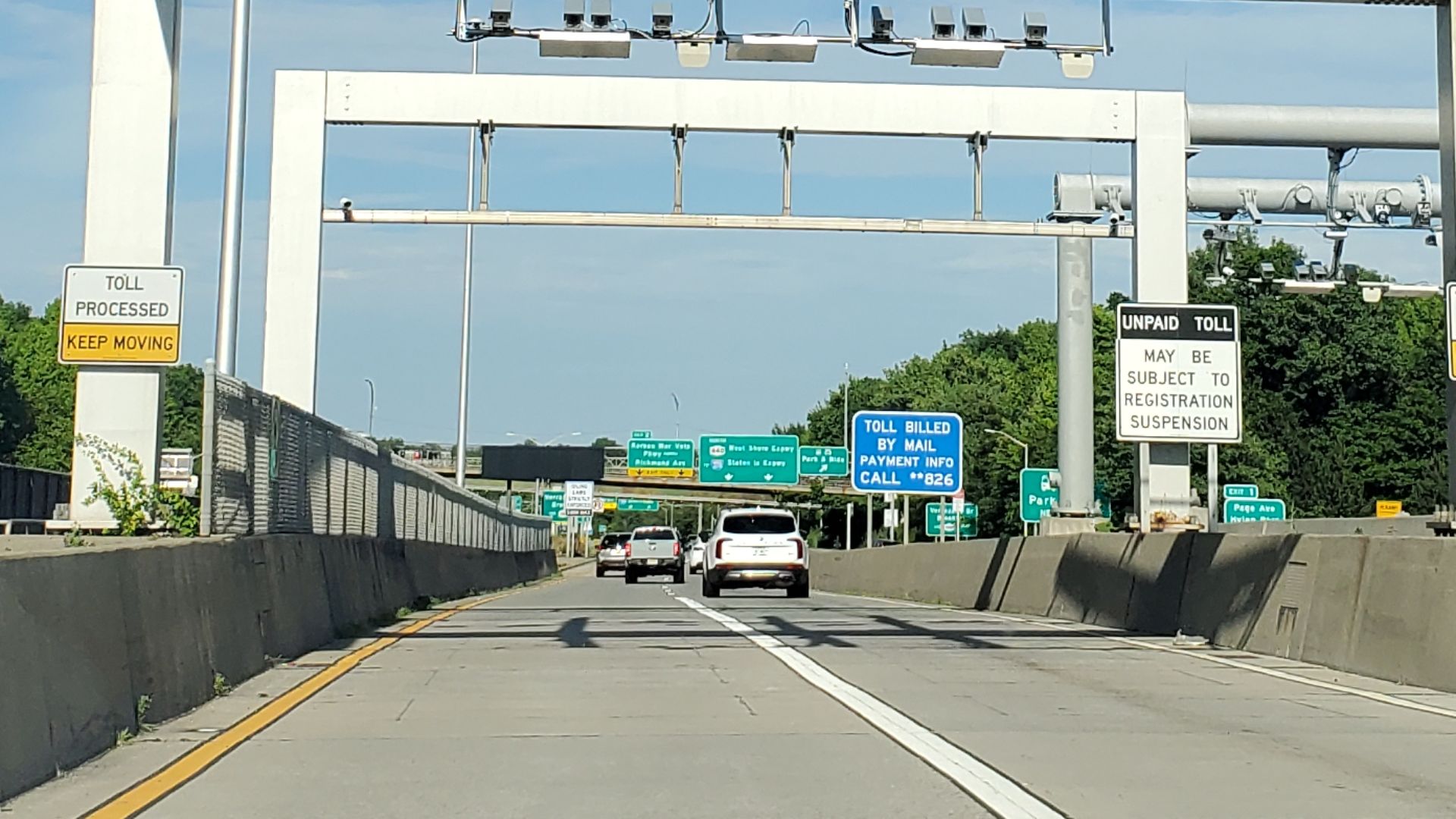 Traveling east from the east end of the Outerbridge Crossing (NJ/NY Route 440) above Arthur Kill, at Bridge Street and Page Avenue in Charleston / Richmond Valley, Staten Island. Pictured is the former tollbooth plaza built in the 1970s, now occupied by e