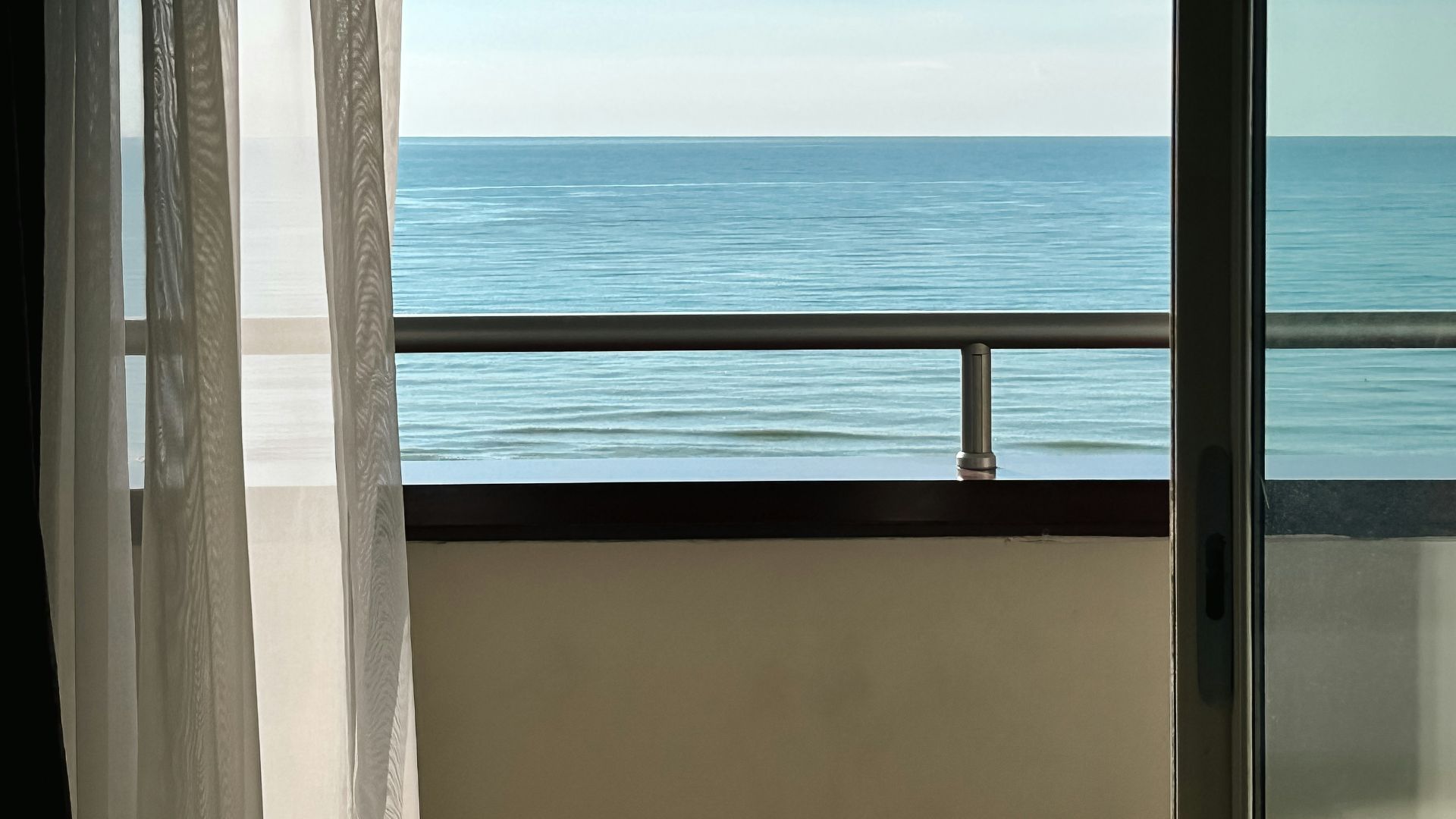 a balcony with a view of the ocean