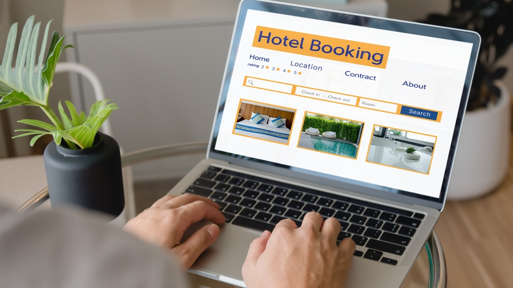 Person using laptop search hotel booking.