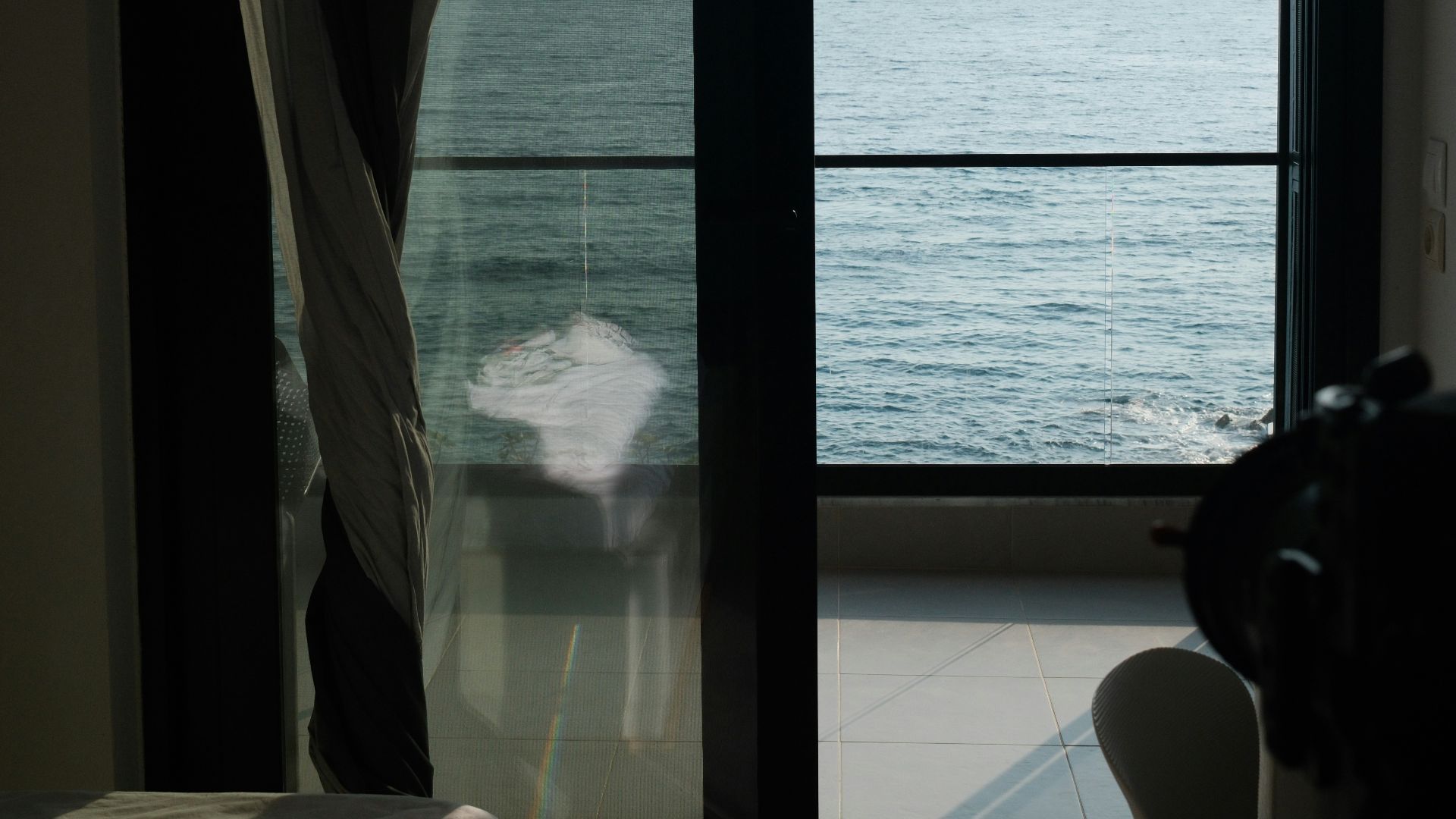Ocean view from a bedroom with a balcony