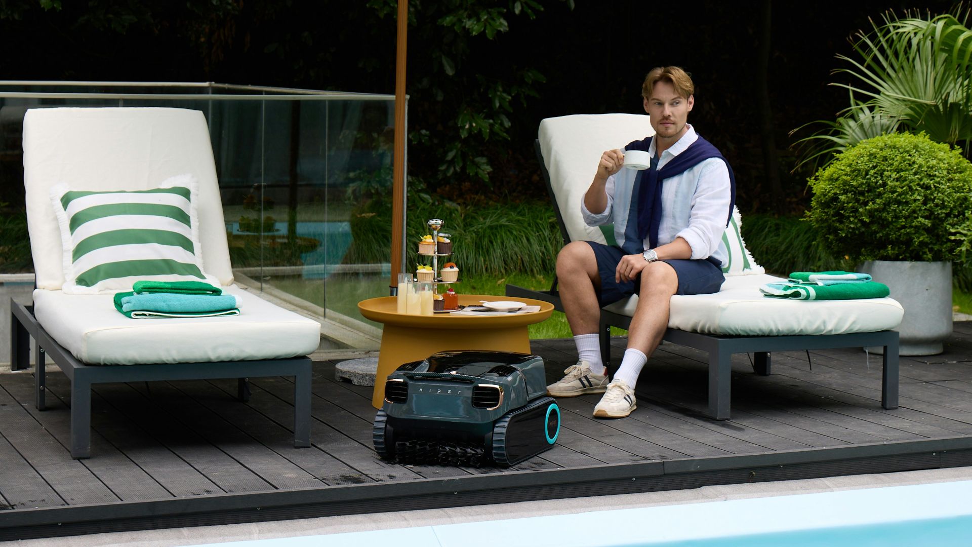 Man relaxing by the pool with a drink