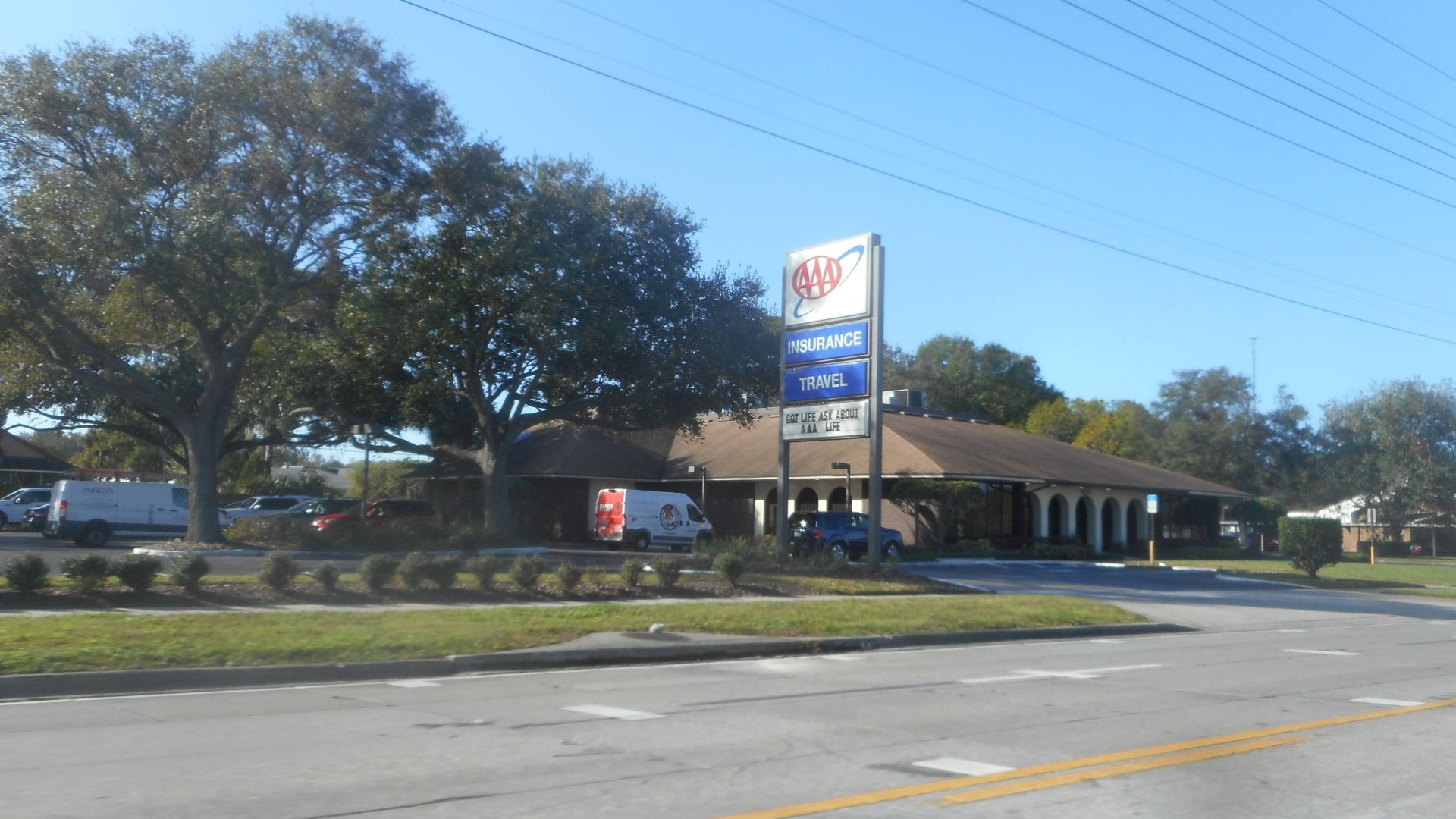 An American Automobile Association insurance office and travel agency on the eastbound side of U.S. Route 92 and hidden Florida State Road 546 in Lakeland, Florida. The office is located near the southwest corner of US 92/FL 546 and Interlachen Park which
