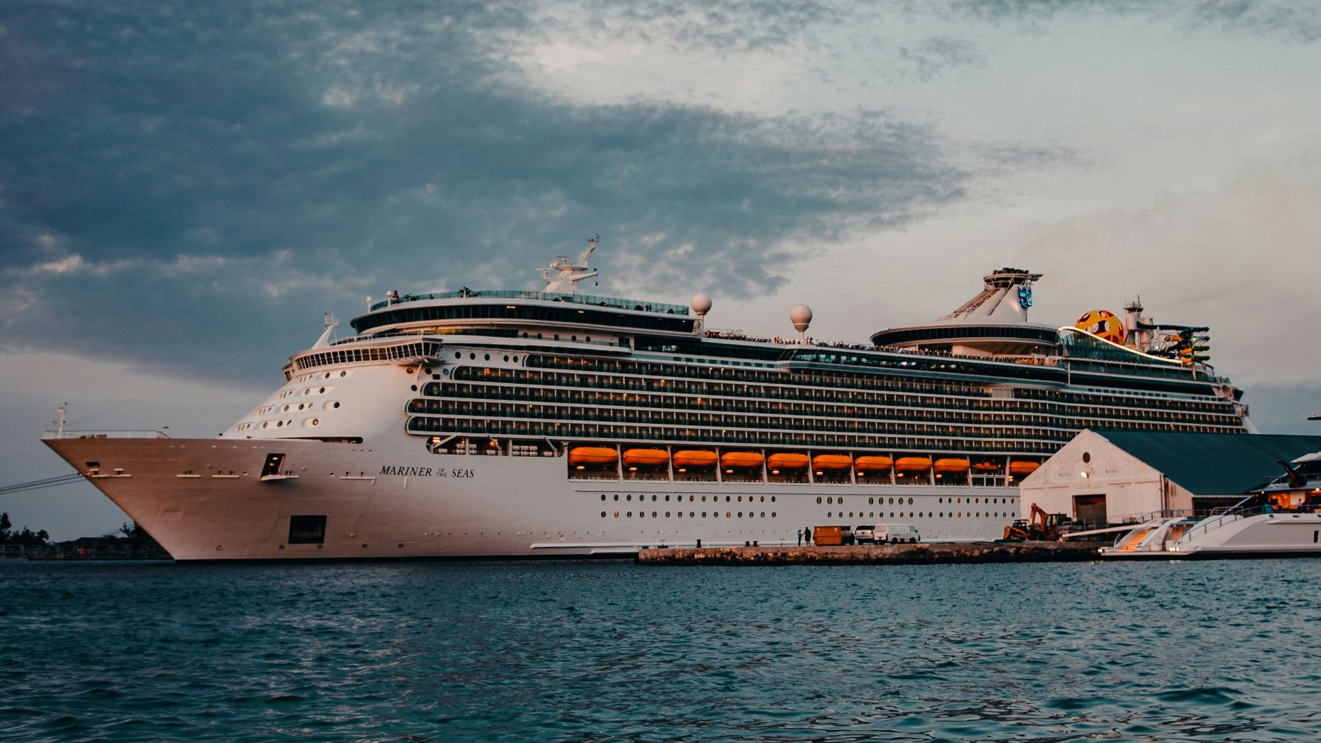 white cruise ship on sea under white clouds and blue sky during daytime