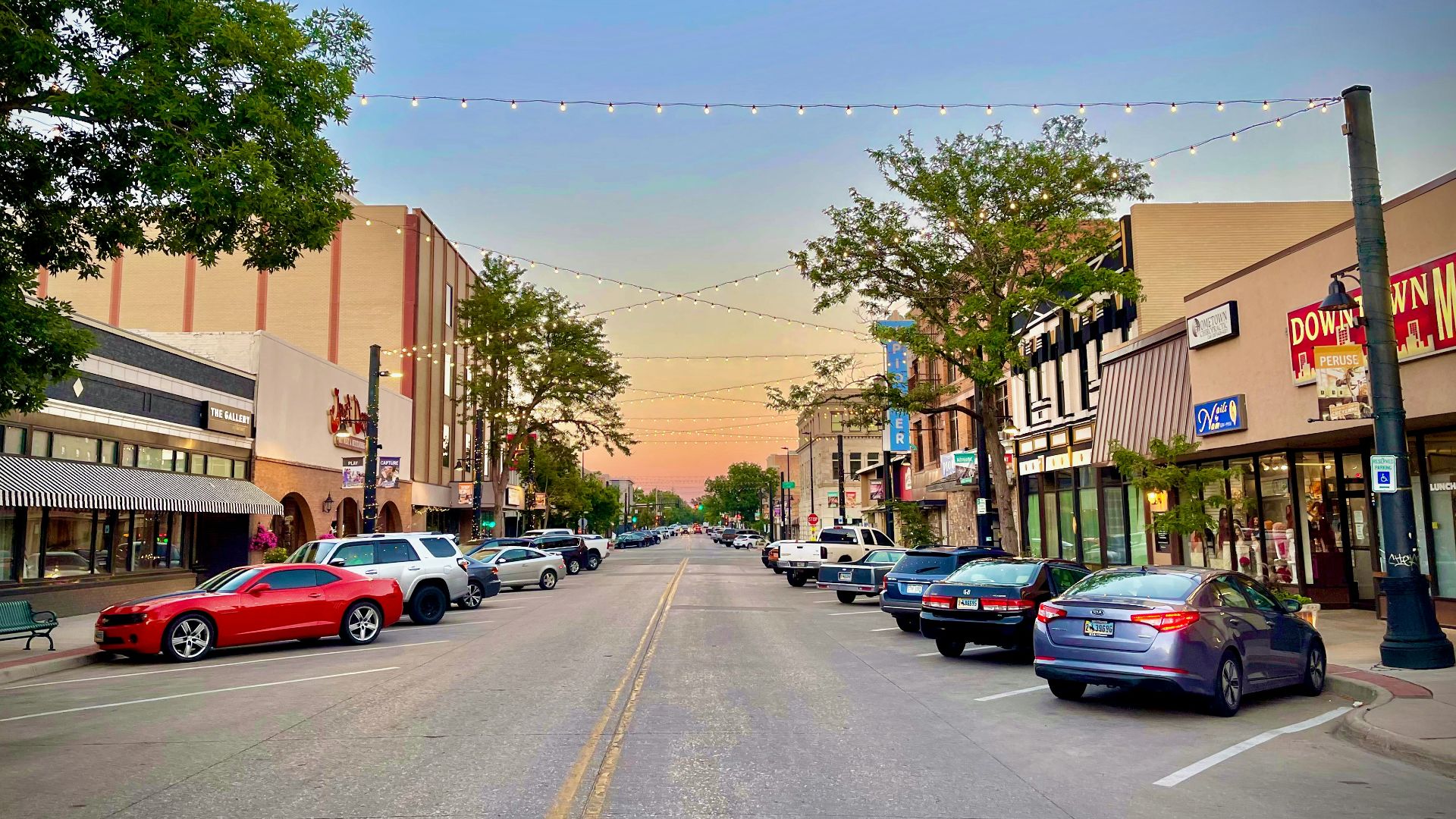 a street with cars parked on both sides of it
