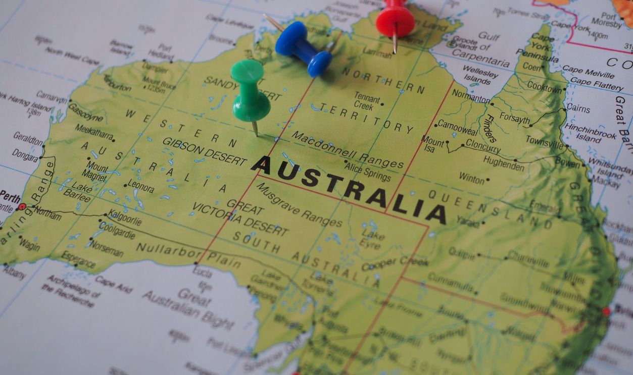 Close-up of a map of Australia featuring colorful pushpins marking locations
