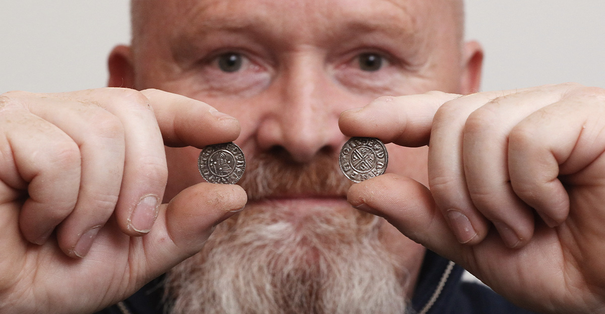 Builder and metal detectorist Don Crawley holds two particularly rare Anglo Saxon silver pennies, produced by a previously unrecorded mint in Lincolnshire, and which form part of a hoard of ninety nine Anglo Saxon silver pennies which he unearthed in Suffolk. 
