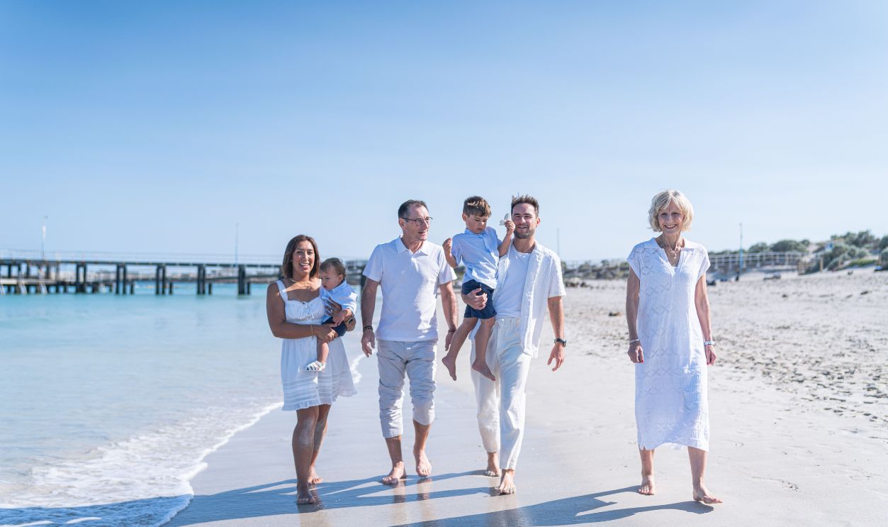 Happy multi-generational family enjoying a beach day together