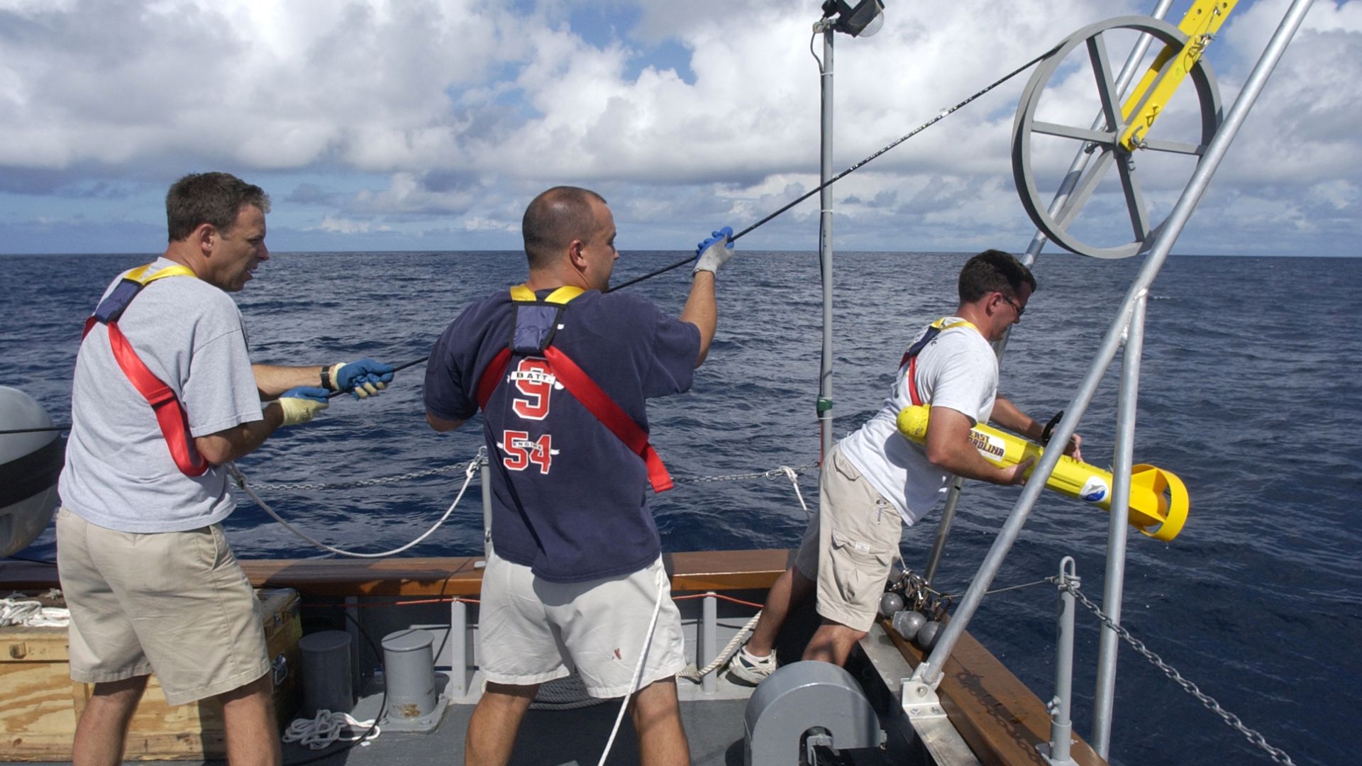 Atlantic Ocean (Aug. 27, 2004) - Staff archeologist Frank Cantelas, left, and crew aboard the Office of Naval Research (ONR) vessel YP-679, Afloat Lab, retrieves the Towfish side scan sonar unit at the end of the day. The National Oceanic and Atmospheric 