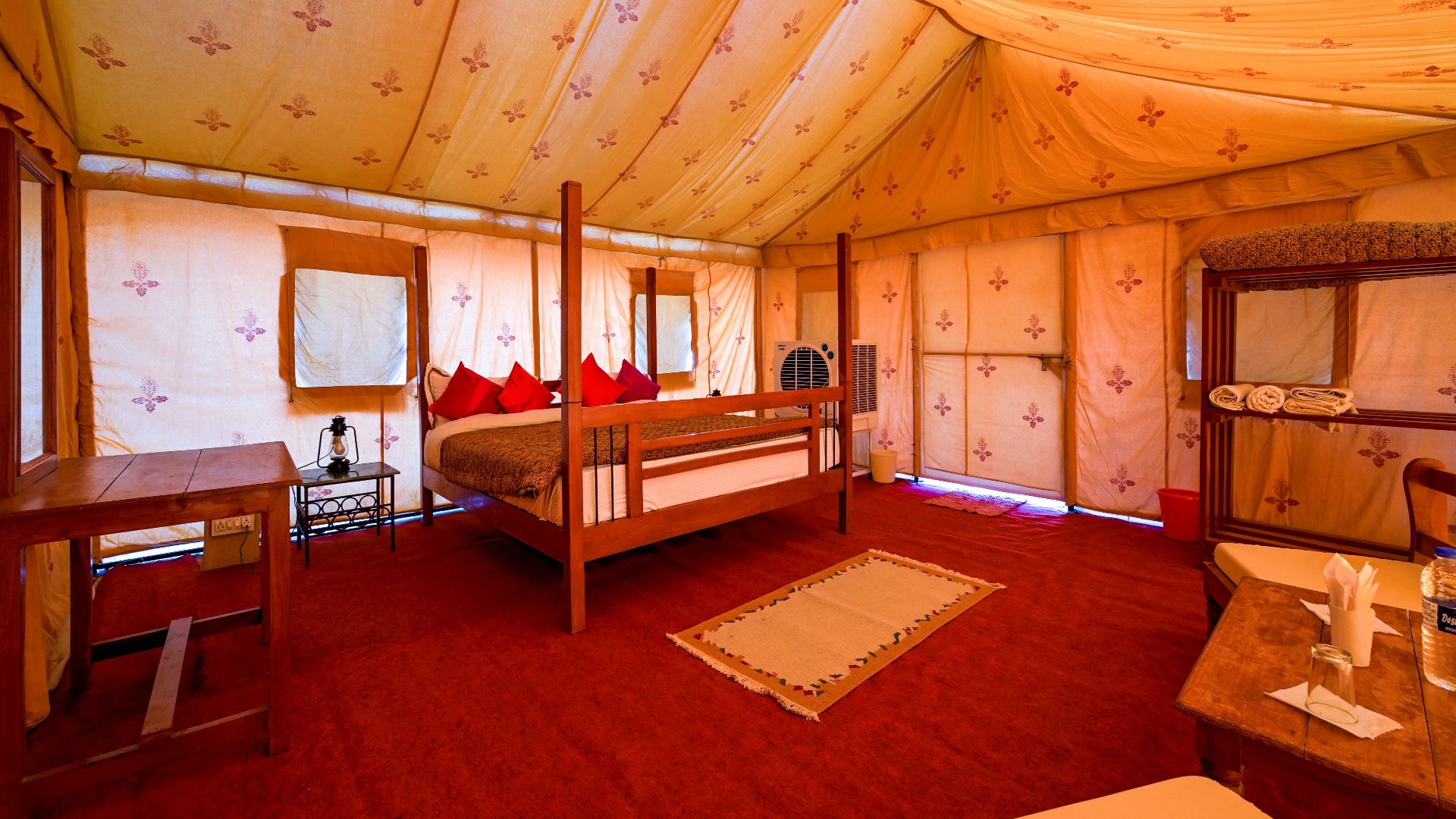 Explore the cozy interior of a desert camp tent in Jaisalmer, India, featuring elegant decor and comfort.