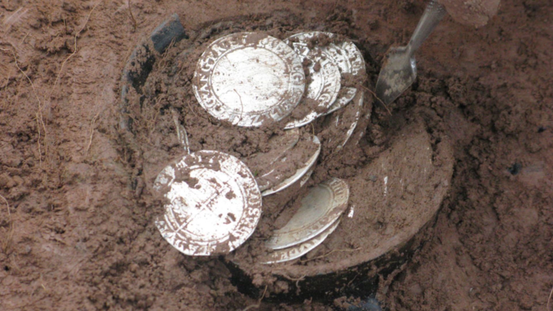 Bitterley, Shropshire (2011 T89)
Hoard of Post-Medieval coins and their container
This hoard was found at Bitterley, Shropshire on 17 February 2011 by a metal-detector user. The finder did not remove the hoard from the ground himself, but notified the Por