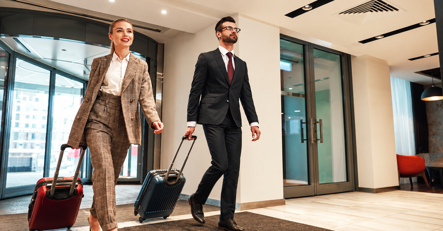 Couple on a business trip doing check-in at the hotel