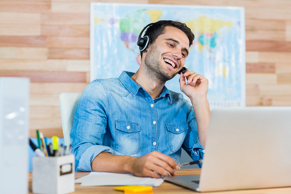 Handsome travel agent speaking with customer 