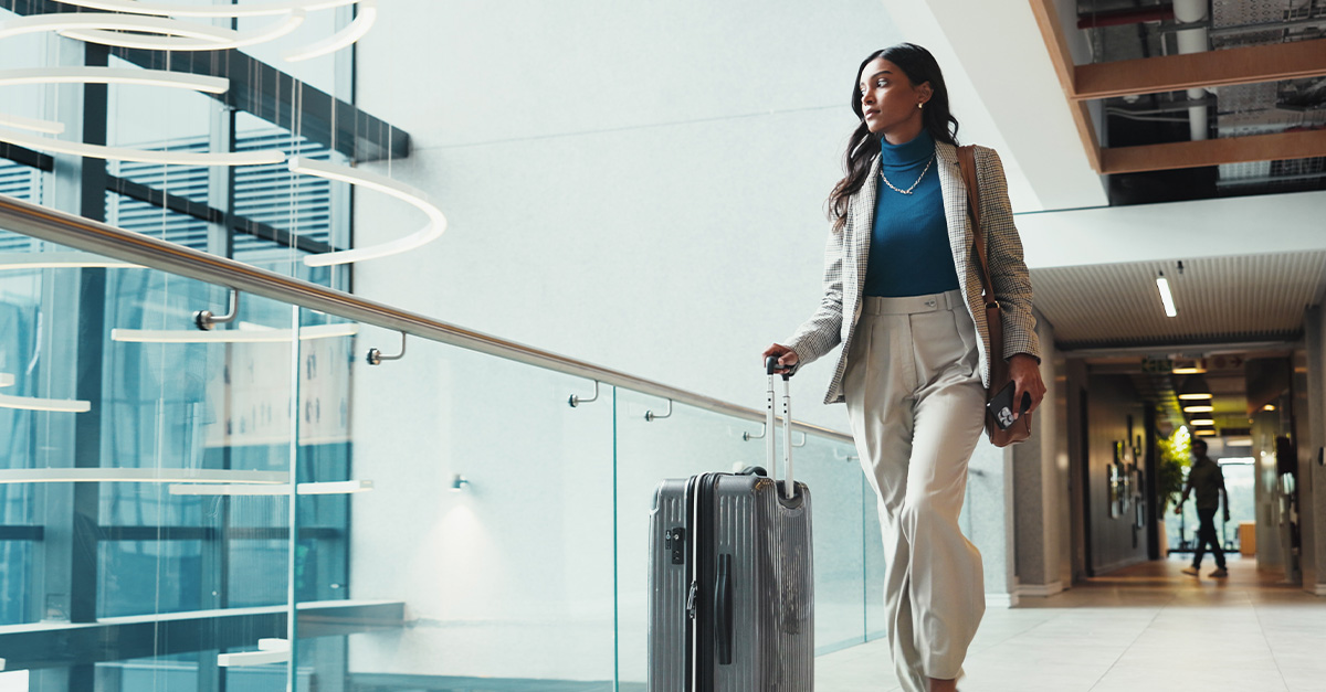 Businesswoman with suitcase in airport for travel, departure or thinking of flight schedule. Professional, company representative or bag in lobby for international trip, global opportunity or retreat