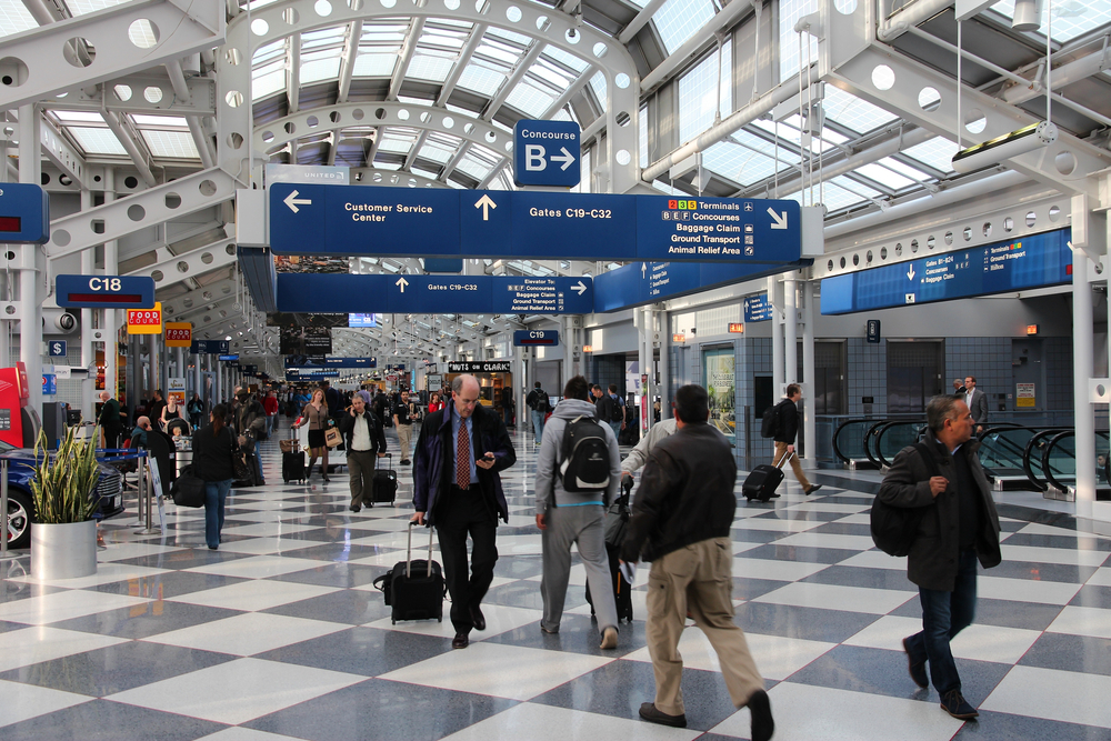 CHICAGO, USA - APRIL 15, 2014: Passengers walk to gate at Chicago O'Hare International Airport in USA. It was the 5th busiest airport in the world with 66,883,271 passengers in 2013.