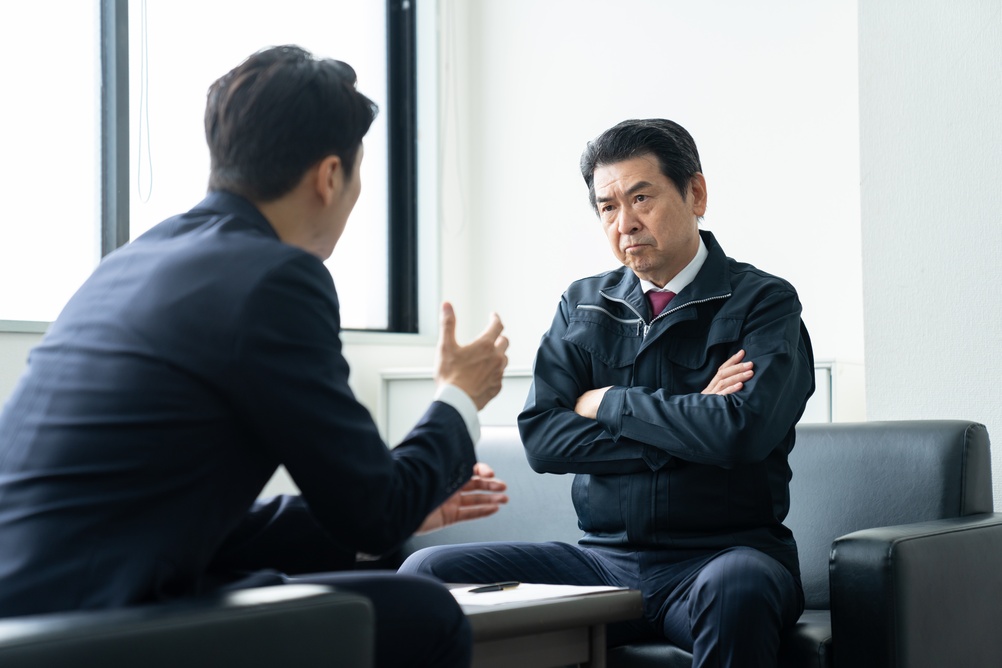 Middle-aged businessmen receiving sales pitches in their offices