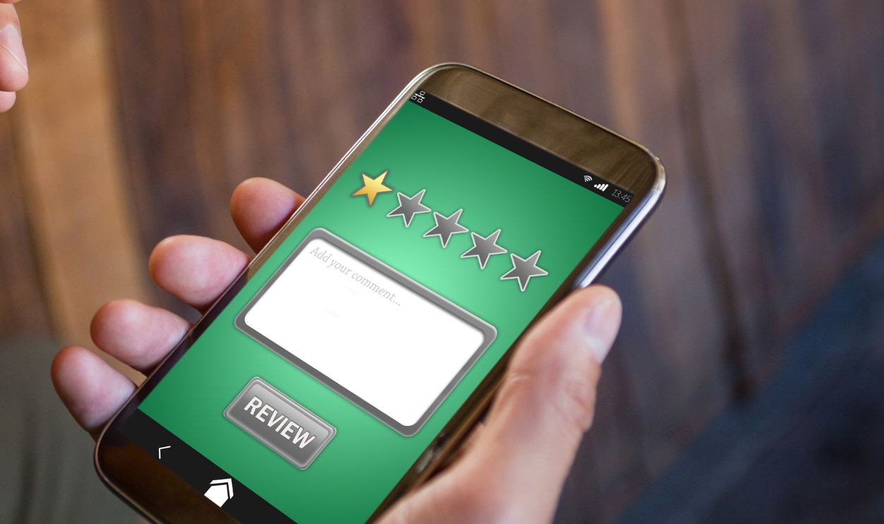 Satisfaction against cropped hands of man using phone