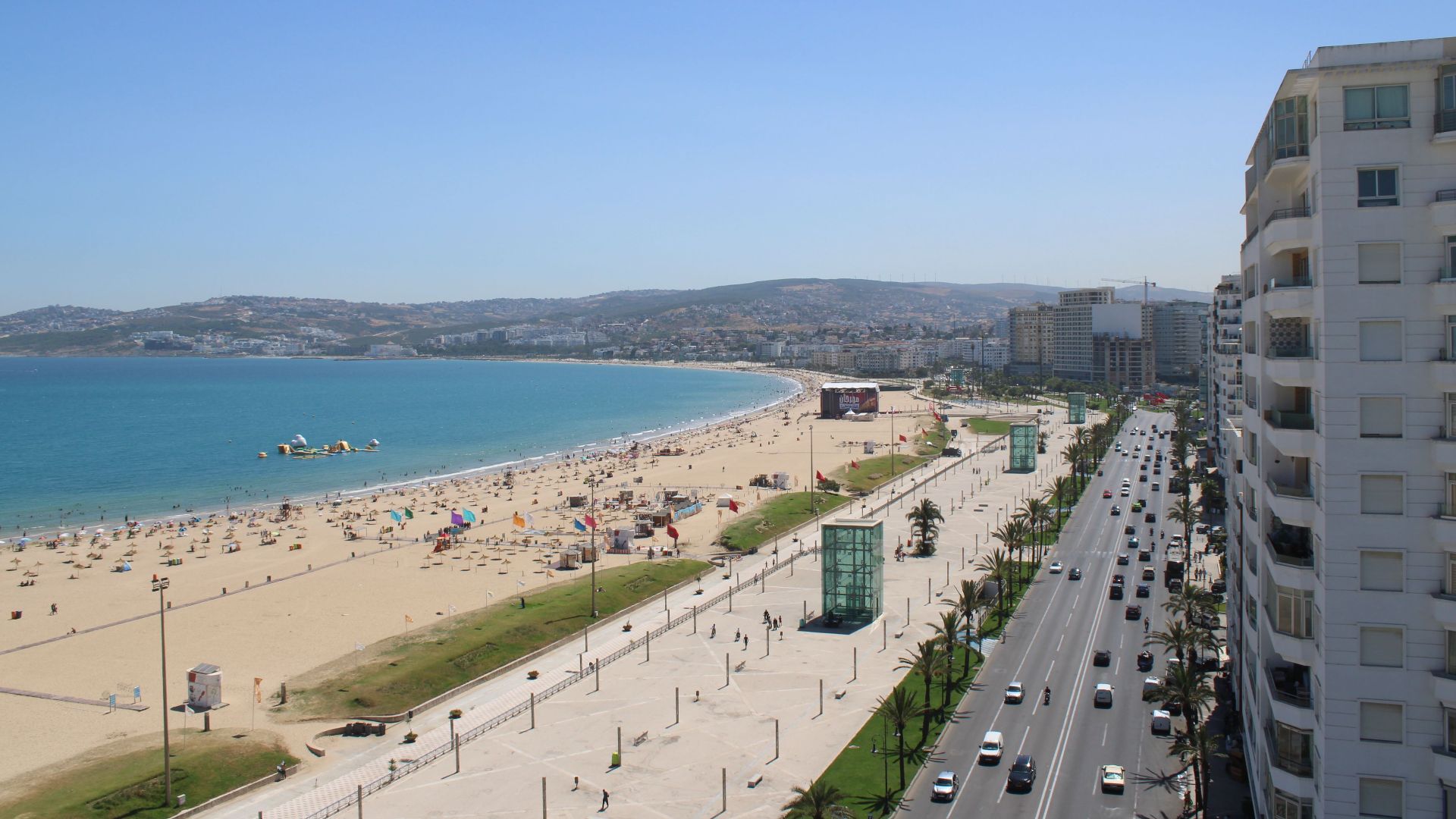 Stunning aerial view of Tangier's sandy beach and bustling city in Morocco.