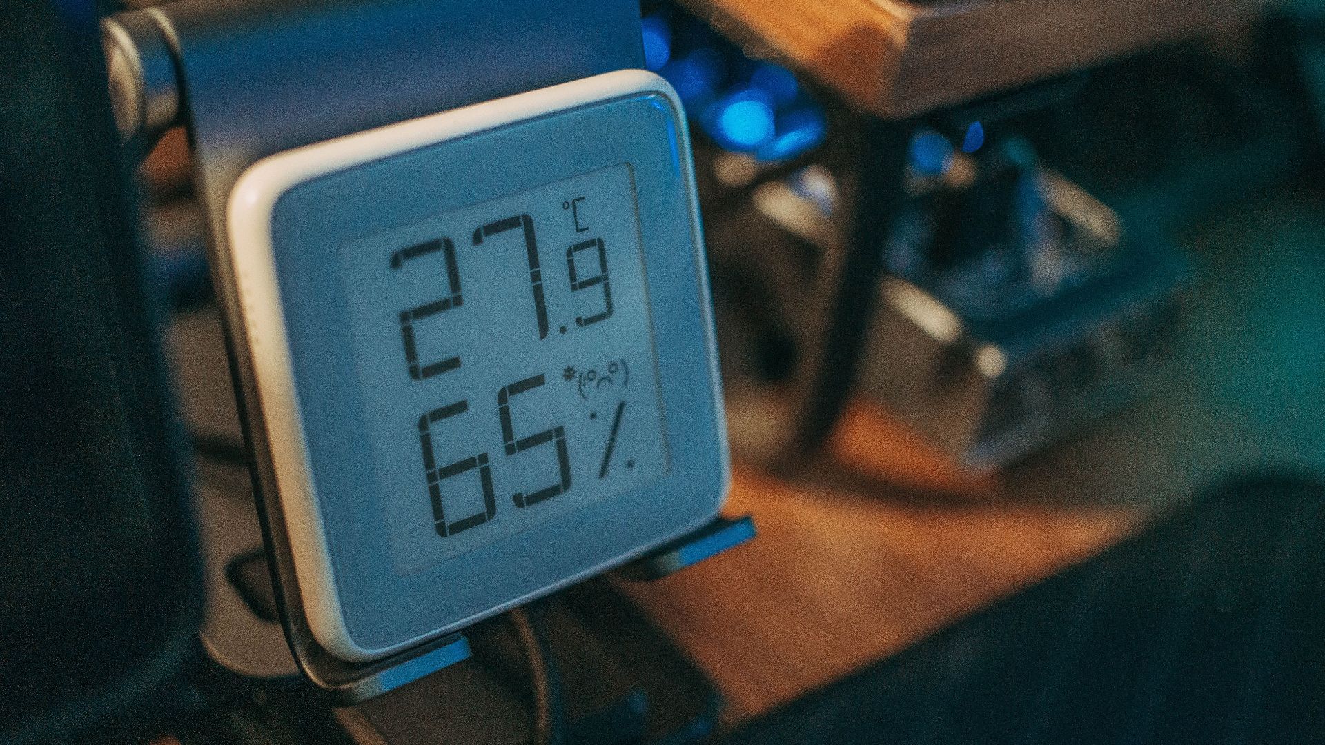 Close-up of a digital hygrometer showing temperature and humidity indoors.