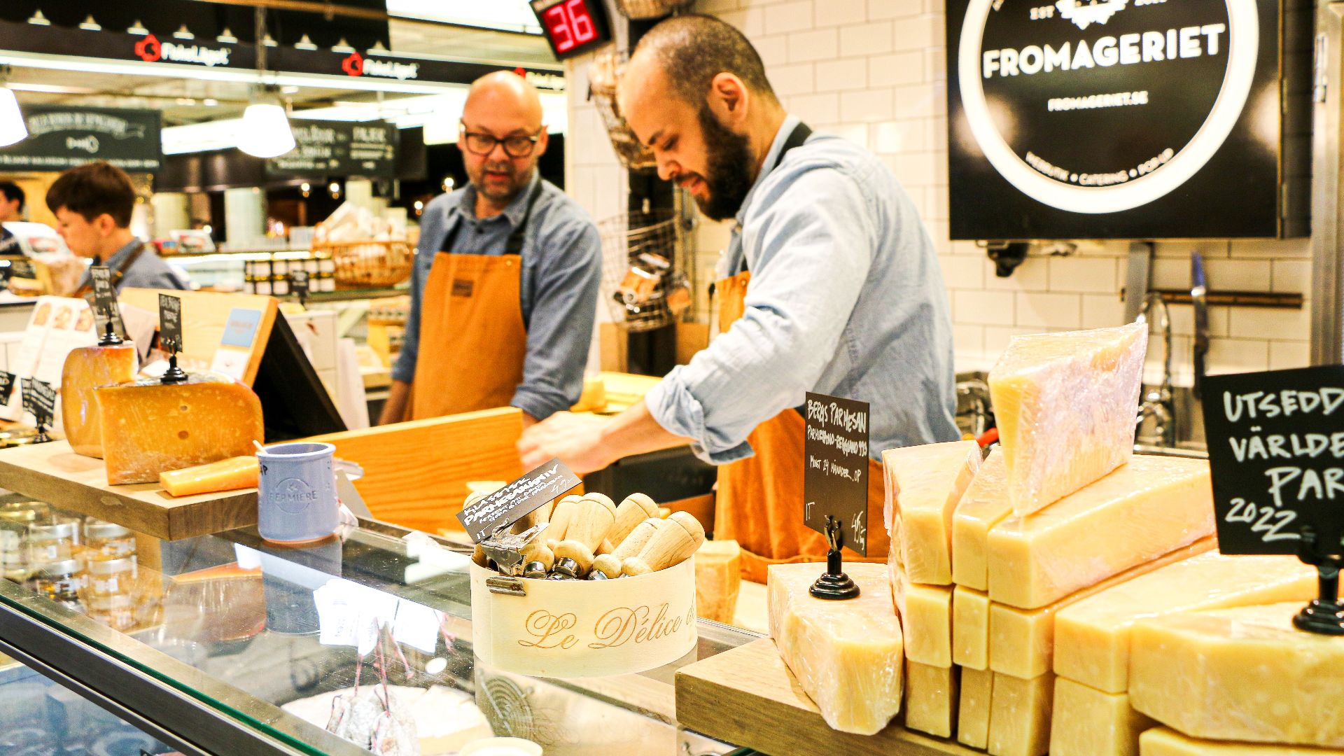 Cheese sellers at Fromageriet counter in Stockholm market.
