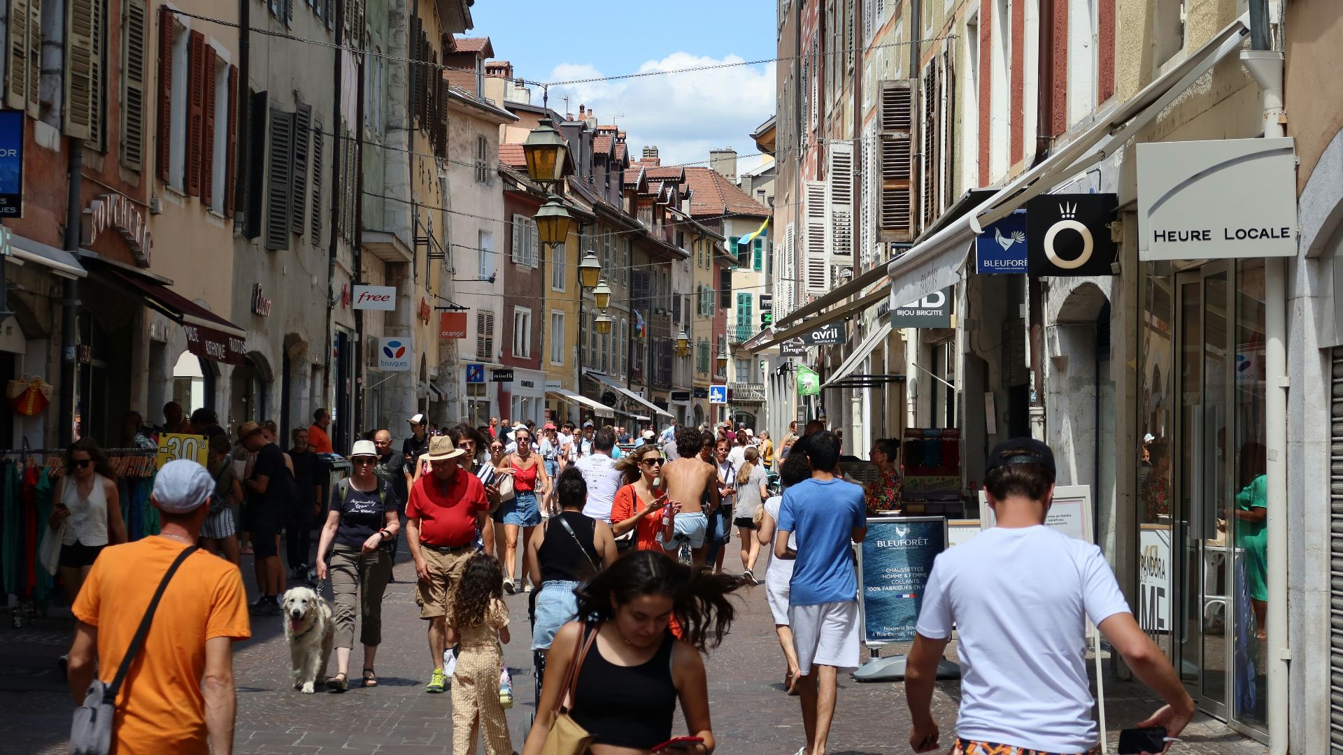 a group of people walking down a street