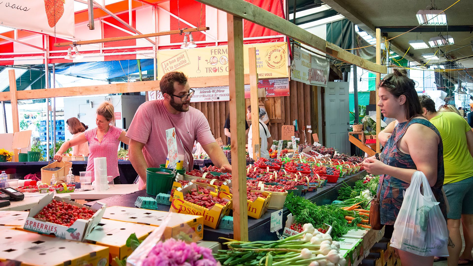 Bustling farmers market with fresh fruits, vegetables and people exploring vibrant stalls.