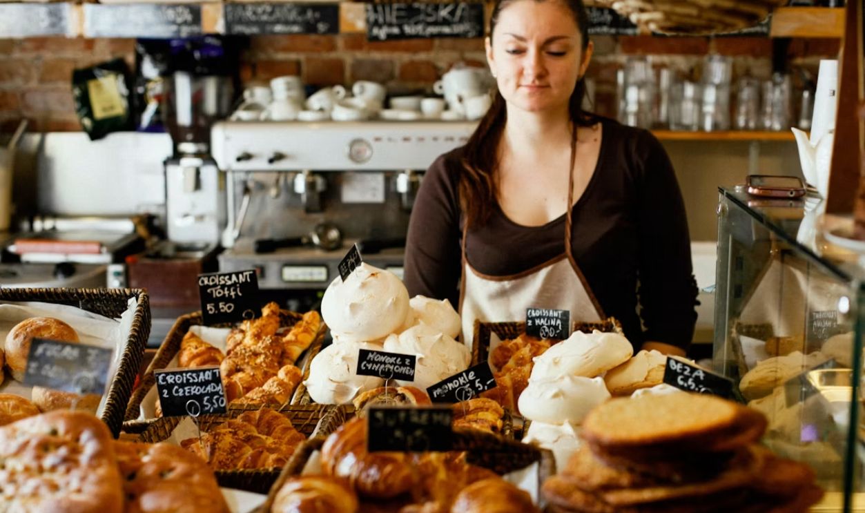 woman on counter near breads