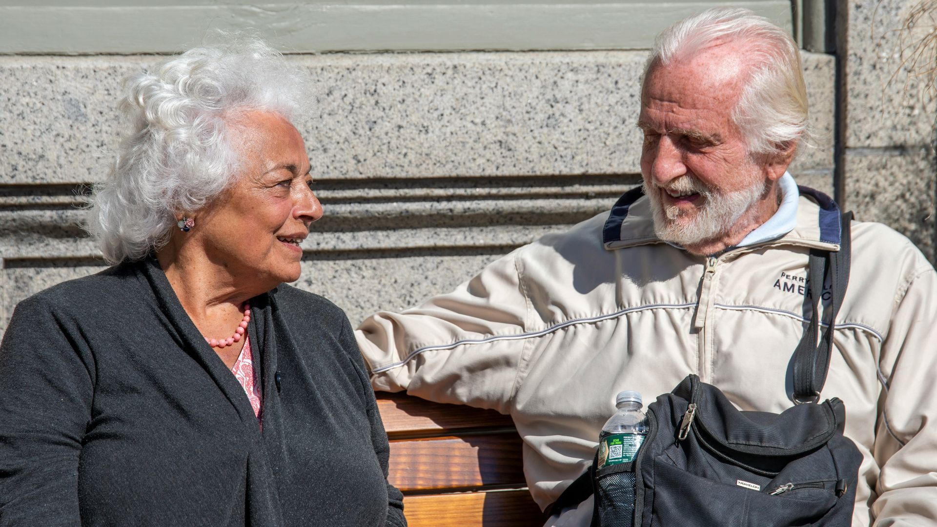 a man and a woman sitting on a bench