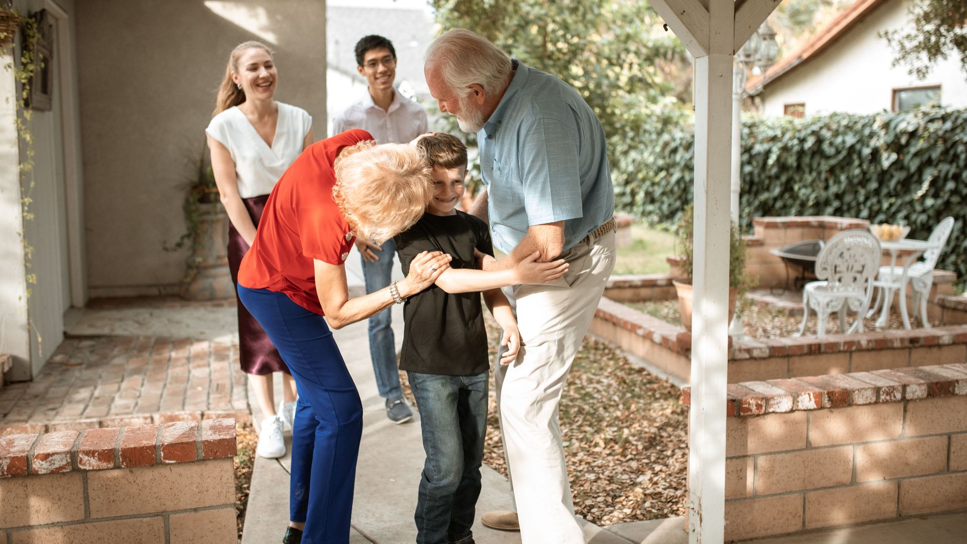 Multi-generational family sharing a joyful moment on the patio.