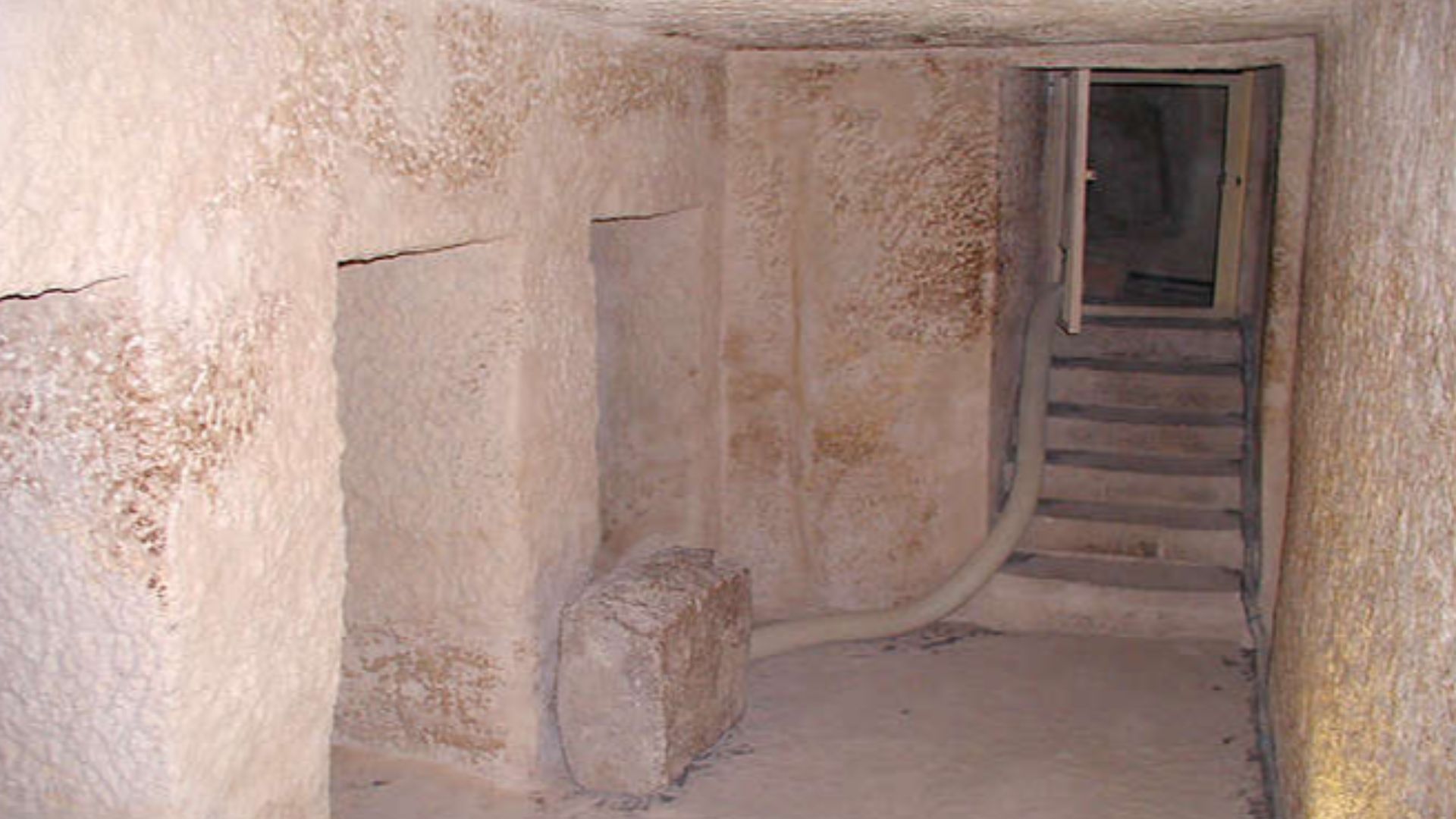 Menkaure's Pyramid - Looking back towards the entrance of the Chamber with five niches. The Burial Chamber is further down the passage to the right that is visible through the door.