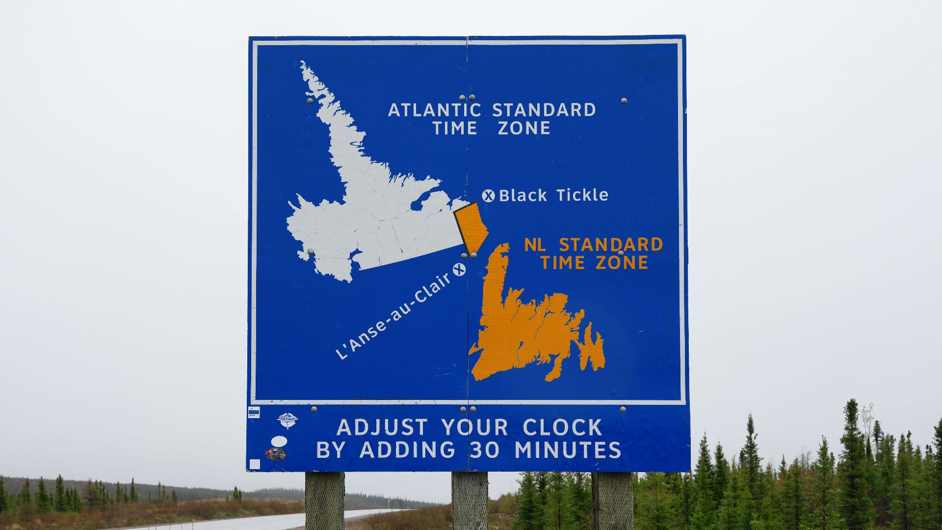 Newfoundland time-zone sign on Trans-Labrador Highway between Cartwright Junction and Port Hope Simpson, marking the change from Atlantic Time to Newfoundland Time in southeastern Labrador.