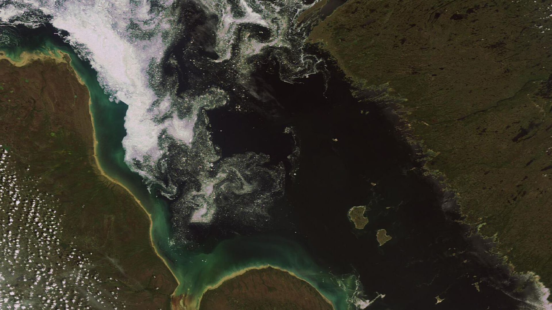 Canada’s James Bay, featured in this Envisat's MERIS image acquired on 2 July 2007, is located between the provinces of Quebec (right) and Ontario (left). The bay, 443 km long and 217 km wide, contains numerous islands. The crescent-shaped Akimiski Island