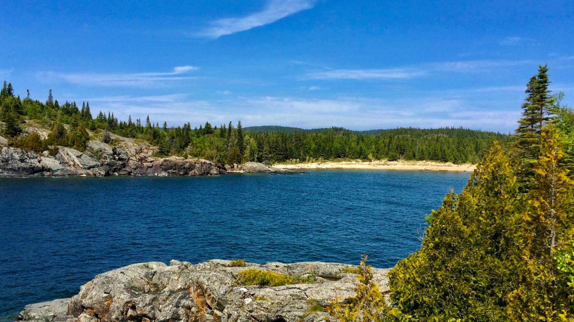 A view across Horseshoe Bay toward the beach of the same name, as seen on a July 2015 afternoon from the Southern Headland Trail at Pukaskwa National Park, Ontario, Canada.