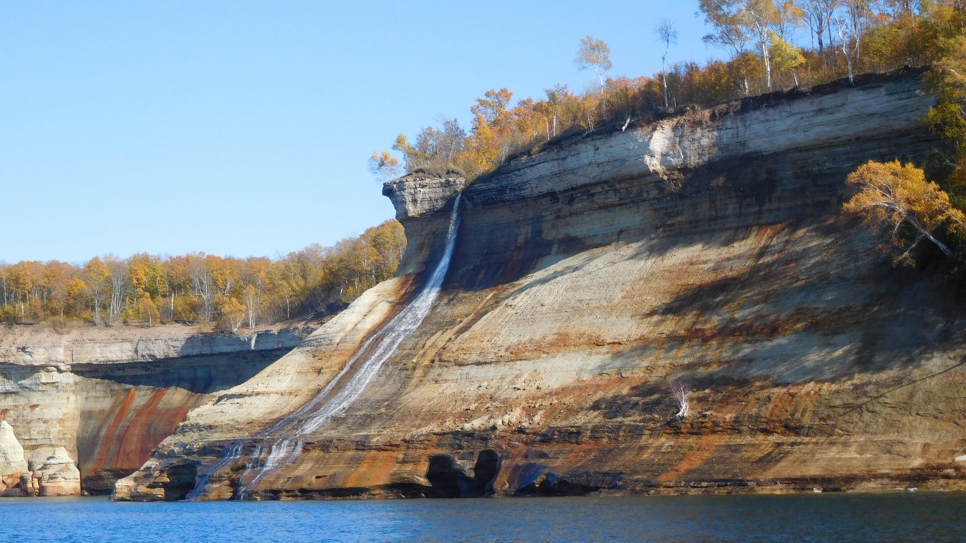 This waterfall drops over a vertical cliff top onto a sloping sandstone cliff. The water then flows into Lake Superior. Fall colored trees are on the cliffs.
Bridalveil Falls
Keywords: pictured rocks national lakeshore; piro; waterfall; lake Superior; fal