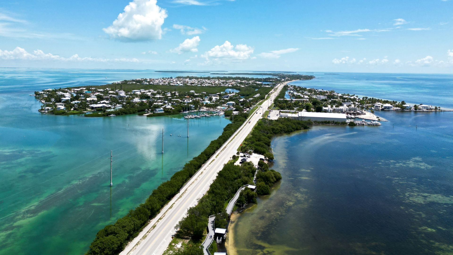an aerial view of a highway and a body of water