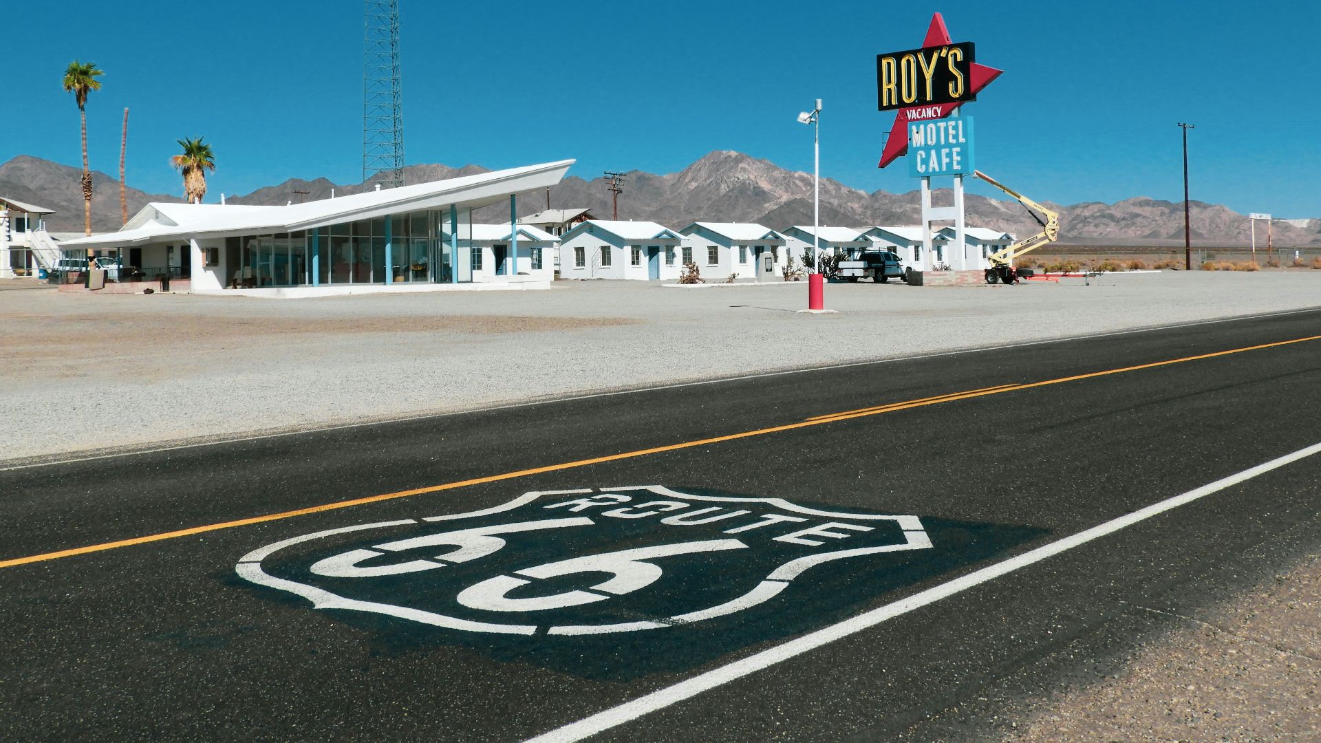 a route 66 sign on the side of a road