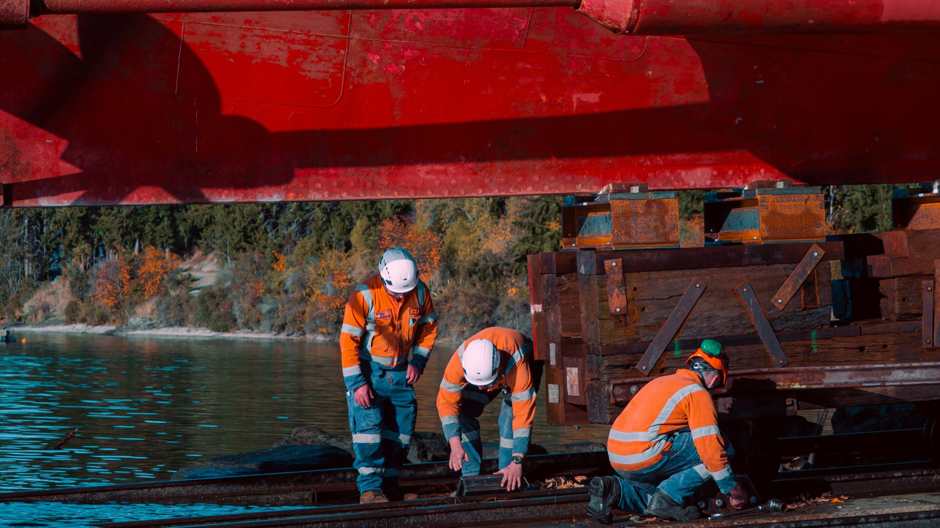 Workers inspect the underside of a boat