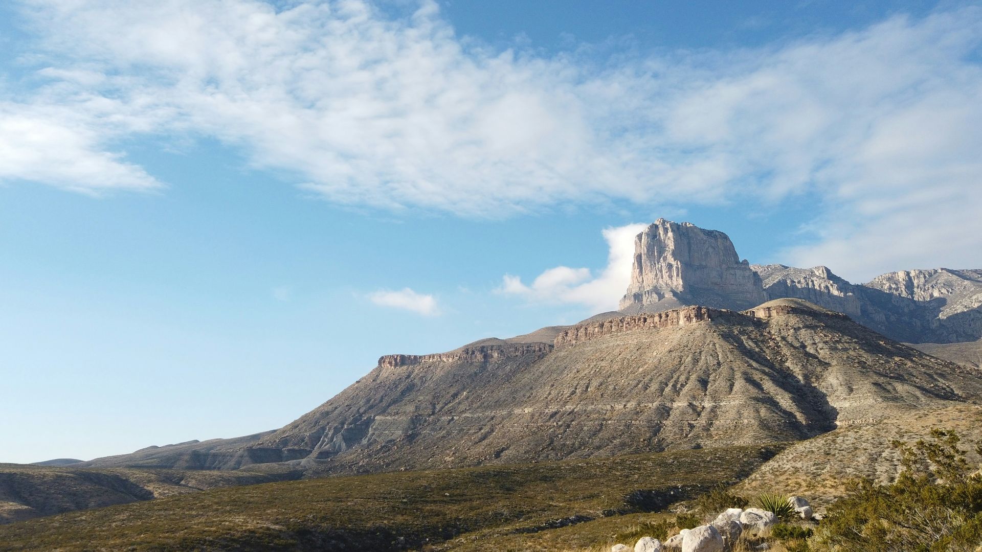 a view of a mountain with a cloud in the sky