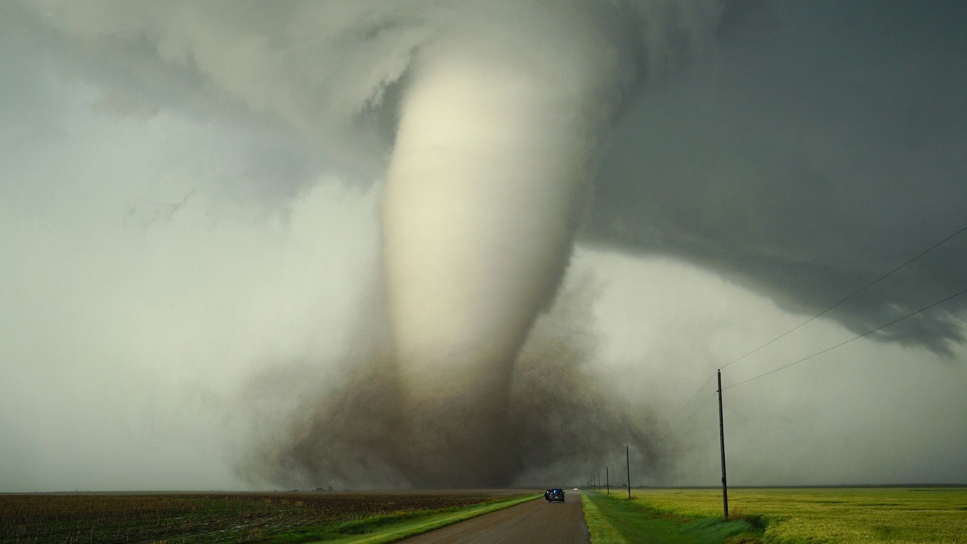 a large tornado is coming down the road