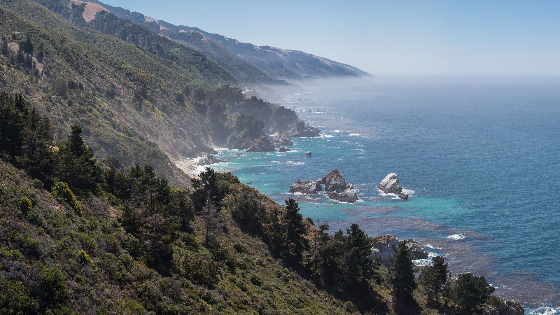Central Californian coastline looking south, with the McWay Rocks (with arch) in the foreground, and McWay Cove in the center.