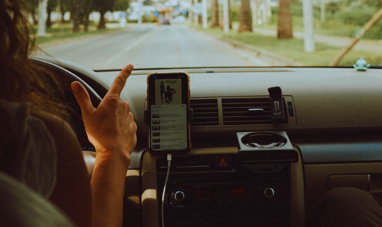 Interior car view with people driving through scenic Faro, Portugal