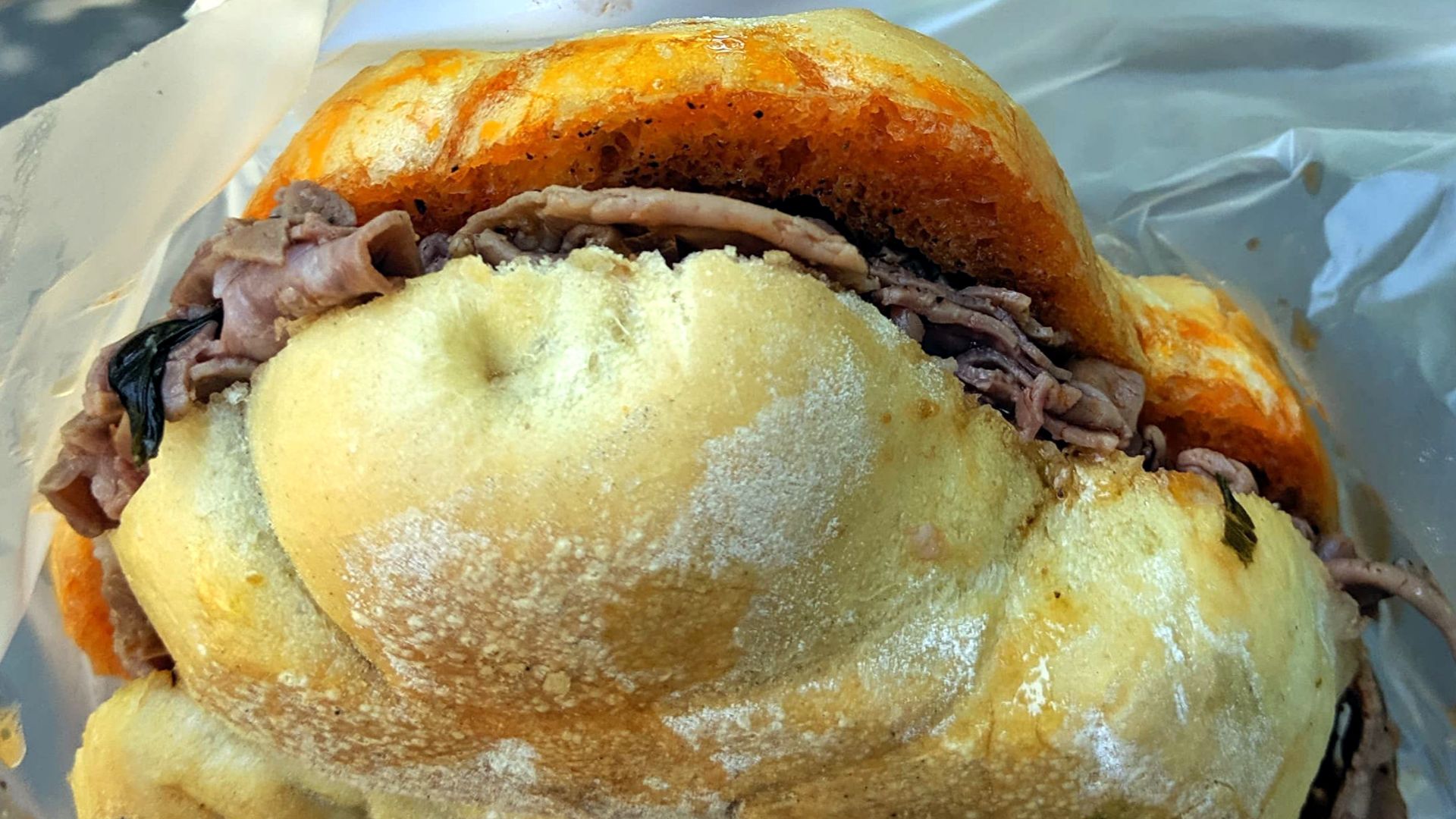 This is a Lampredotto Sandwich, purchased in Florence, July 2019, comprised of the fourth and final stomach of a cow, the abomasum, slow-cooked and served on bread.
