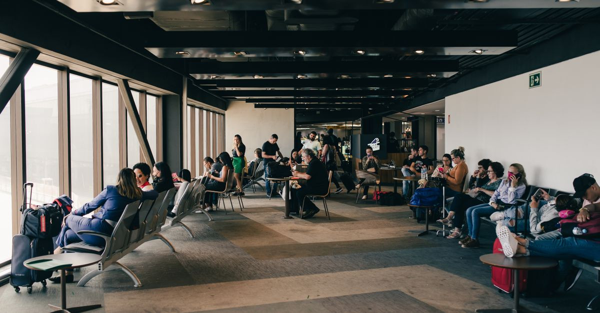 Passengers relaxing in a São Paulo airport waiting area, capturing a travel moment.