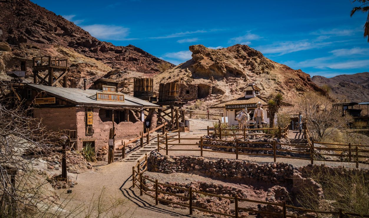 Explore a rustic old west village nestled in a scenic desert setting