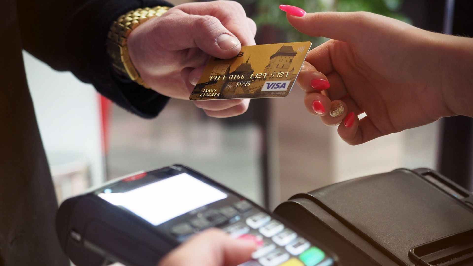 Close-up of a credit card payment being processed at a POS terminal.
