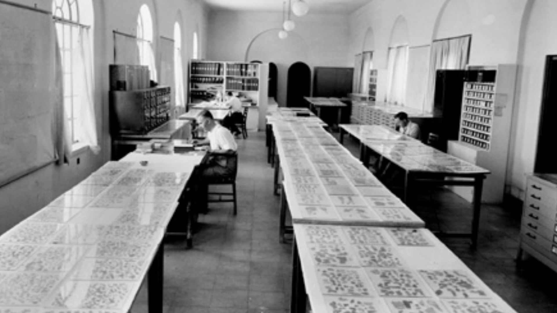 Scholars examining the Dead Sea Scroll fragments.