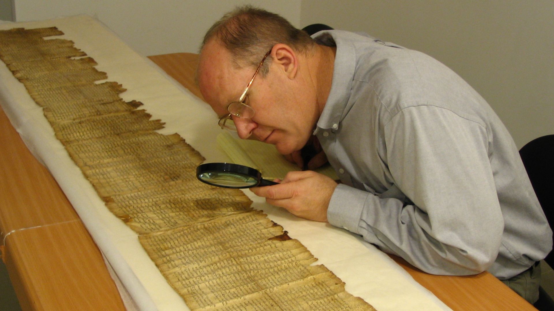 Parry studies the Great Isaiah Scroll (1QIsa-a) in the Dead Sea Scrolls vault (scrollery), Israeli Museum, Jerusalem, Israel.