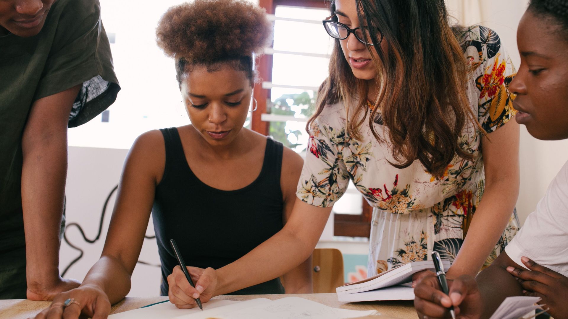 A group of diverse professionals collaborates on a project, fostering teamwork and creativity.